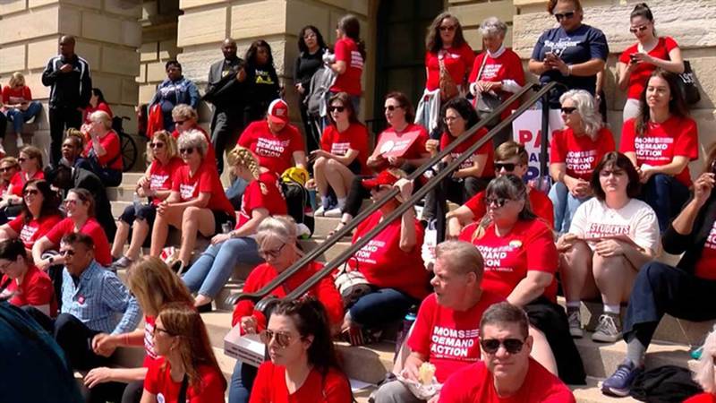 Advocates from the organization Moms Demand Action gather outside the Illinois State Capitol on Tuesday. They are urging lawmakers to pass legislation they believe will reduce gun violence.
