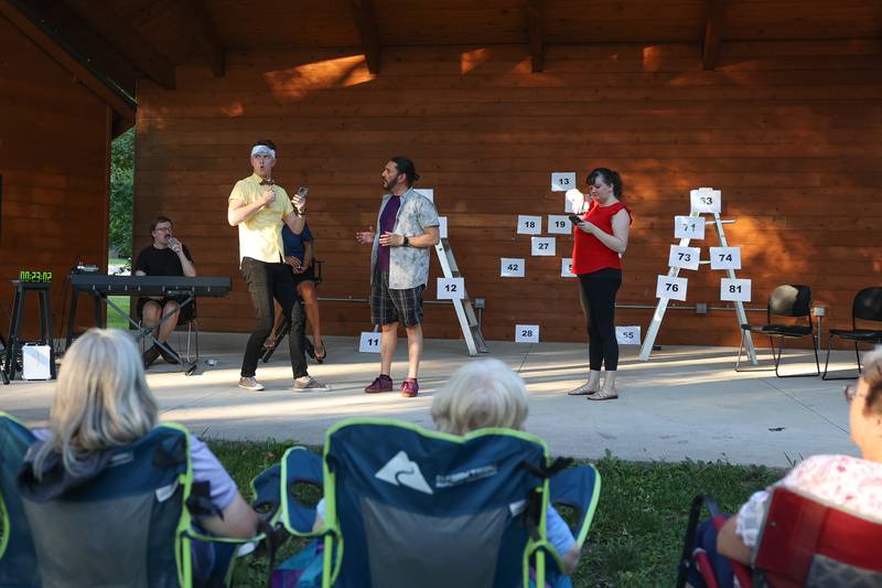 GreenRoom Improv cast members Christian Zierke, left, Sam Barbaro and Jess Smith do an improv only reading text from several audience members phones for their show hosted by the Morris Library on Friday, Aug. 11, 2023 in Morris.