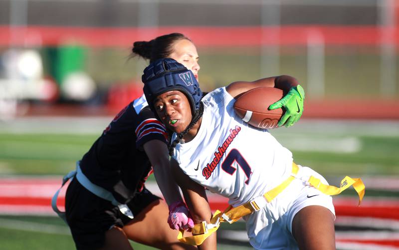 West Aurora’s Aliyah Sylvester has her flag pulled by Yorkville’s Sarah Johnson during a flag football game Wednesday, Sept. 4, 2024 in Yorkville.