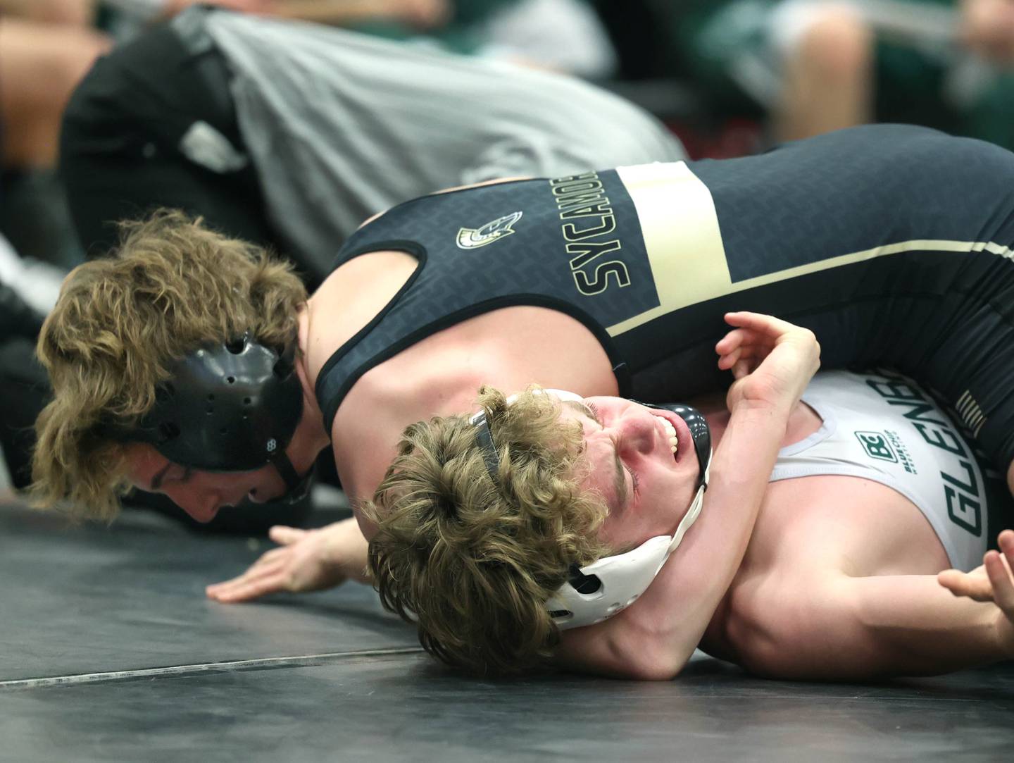 Sycamore’s Jayden Dohogne works to pin Glenbard West’s Cody Bochenski in their 138 pound match Friday, Dec. 29, 2023, during the Don Flavin Invitational wrestling tournament at DeKalb High School. Dohogne won the match with a fall at 5:02.