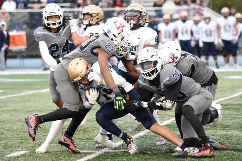 Lemont's Matthew Ciesla, bottom center, is tackled by a host of Kankakee defenders during an IHSA Class 5A playoff game at Kankakee saturday, Nov. 1, 2025.