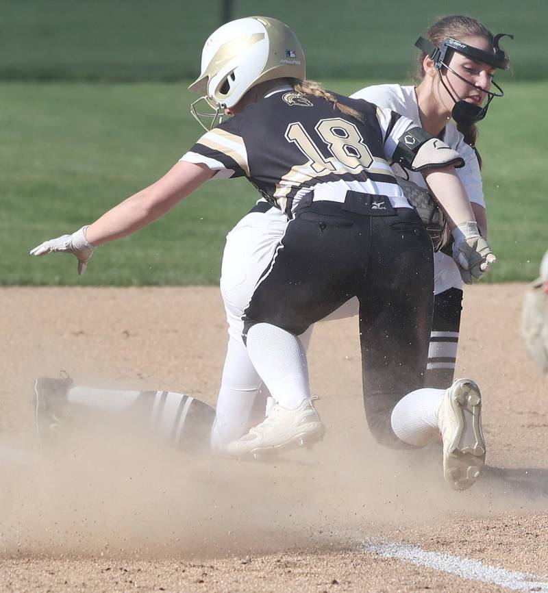 Sycamore's Addison McLaughlin slides in safely with a triple as Kaneland's Kyra Johnson applies the tag Friday, April 28, 2023, during their game at Sycamore High School.