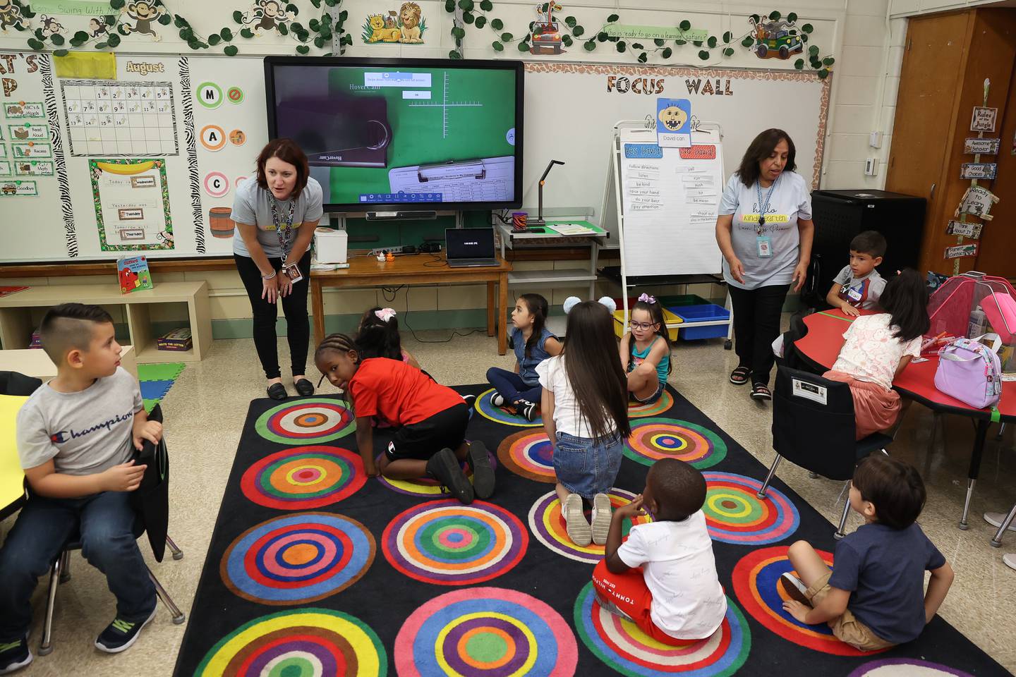 Kindergarten teacher Tiffany Listermann, left, and paraprofessional Estela Paroma work with a class on the first day of school at Taft Elementary on Wednesday, Aug. 16, 2023 in Joliet.