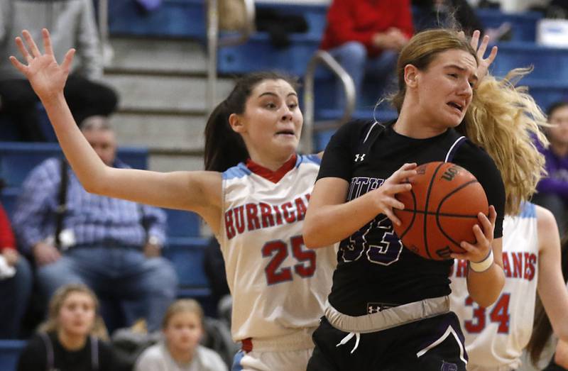 Rockford Lutheran's Hannah Morgan grabs a rebound in front of Marian Central's Kiara Kelly  during a non-conference girls basketball game Monday, Dec. 12, 2022, between Marian Central and Rockford Lutheran at Marian Central Catholic High School, in Woodstock.