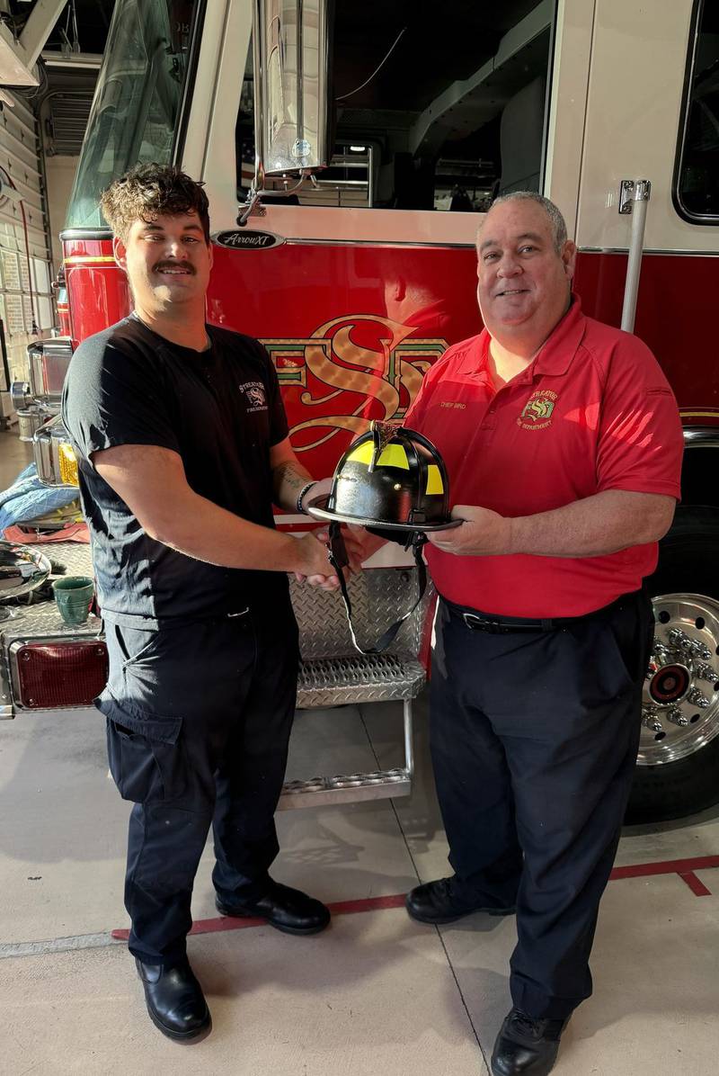 New firefighter Andrew Cooke poses with Chief Gary Bird following his welcome to the Streator Fire Department.
