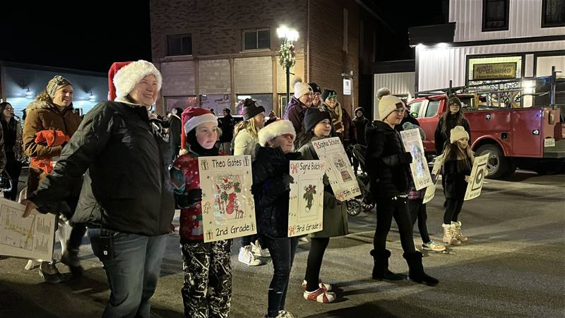 The winners of a holiday coloring contest walk in the 23rd annual Jingle Bell Parade during the Genoa Area Chamber of Commerce's annual Celebrate the Season holiday event on Dec. 6, 2024, in downtown Genoa.