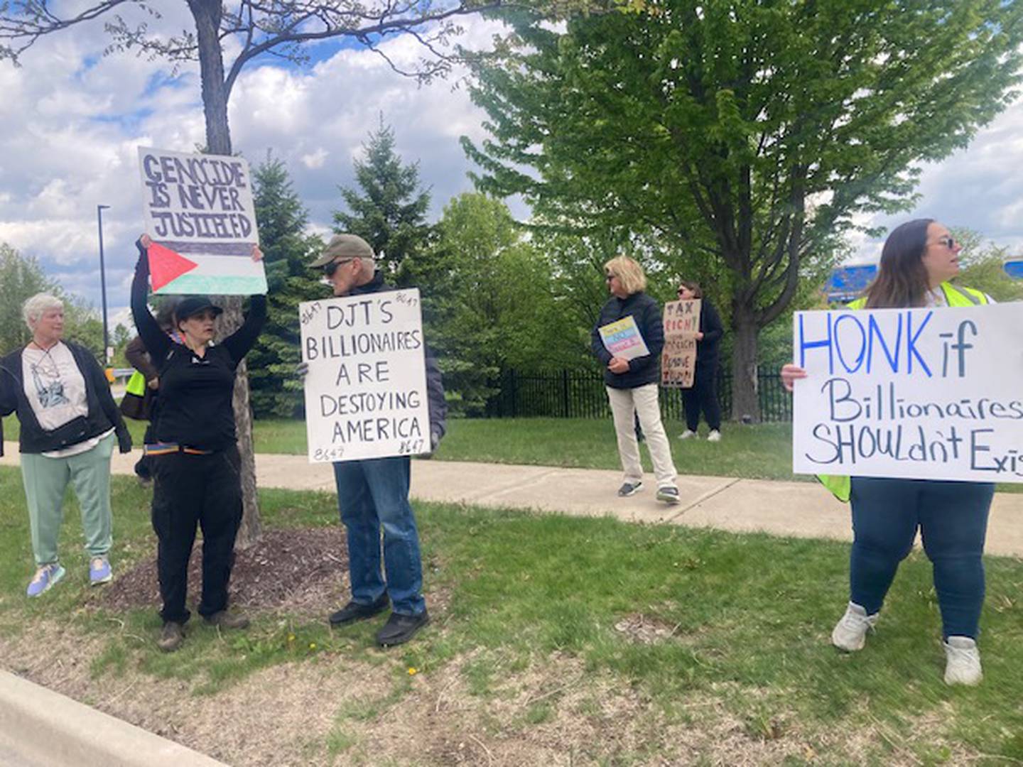 Protesters stand along Farrell Road in Lockport as part of a May Day "Workers Over Billionaires" event on Friday, May 1, 2026.