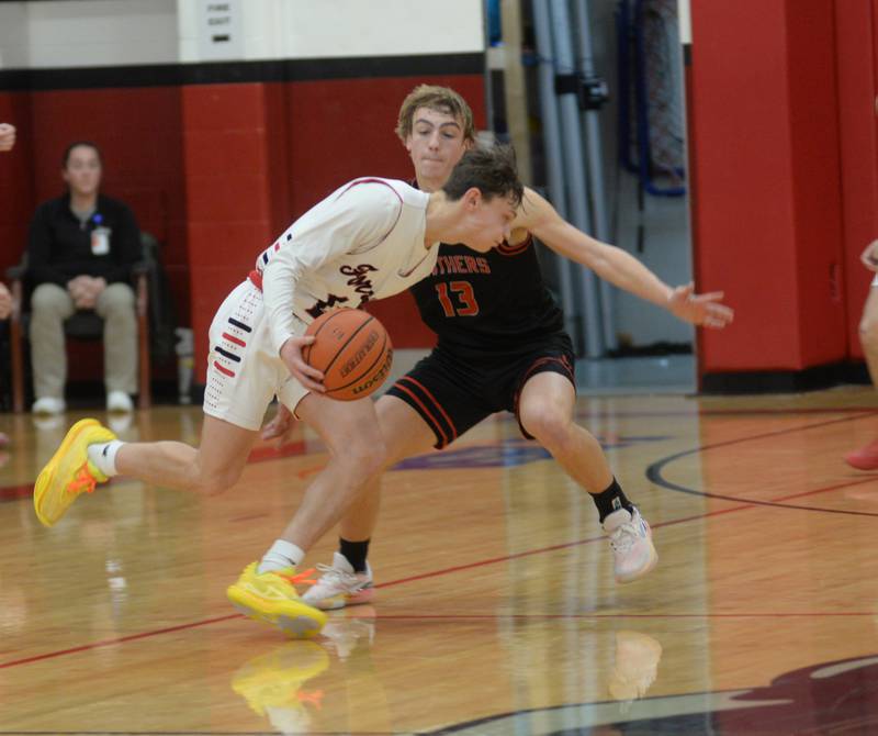 Forreston's Kendall Erdman dribbles as Erie-Prophetstown's Keegan Winckler defends during a Saturday, Dec. 30, 2023 game at the Warkins Memorial Tournament at Erie High School.