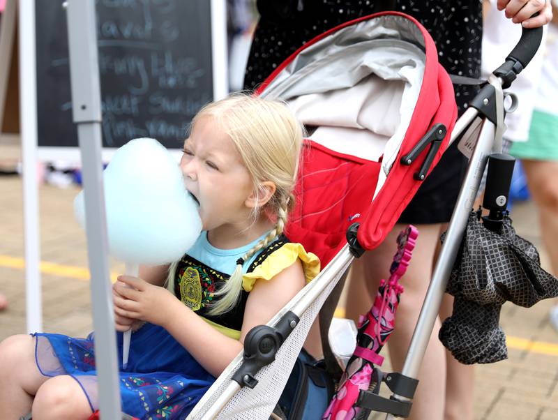 Marni Lambert, 4, digs into some cotton candy during the annual Swedish Days Kids’ Day on Friday, June 20, 2025 at the Geneva Public Library in Geneva.