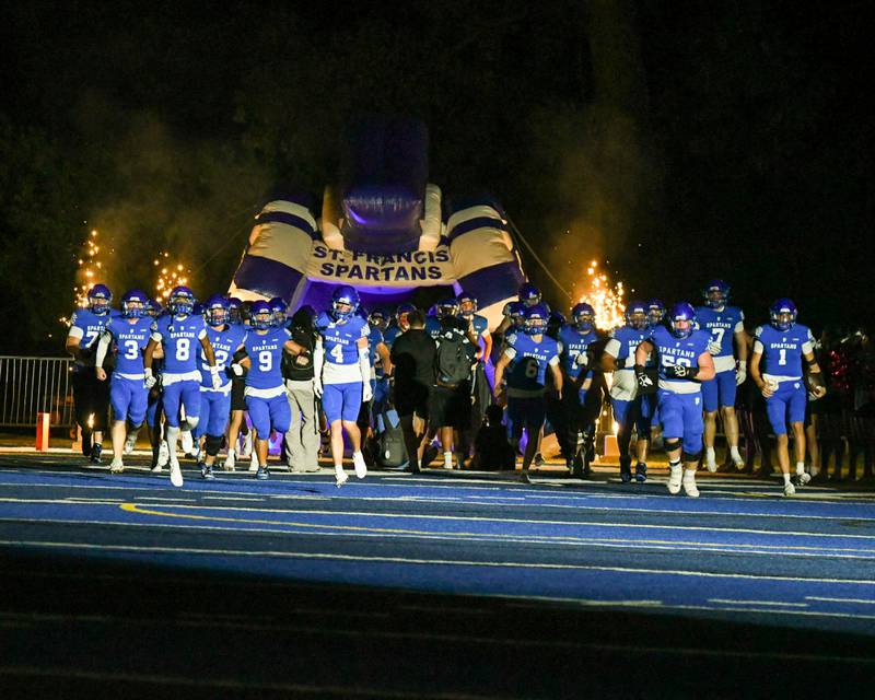St. Francis’s football team takes the field for the start of the game on Friday Oct. 3, 2025, while taking on IC Catholic Prep held at St. Francis High School.