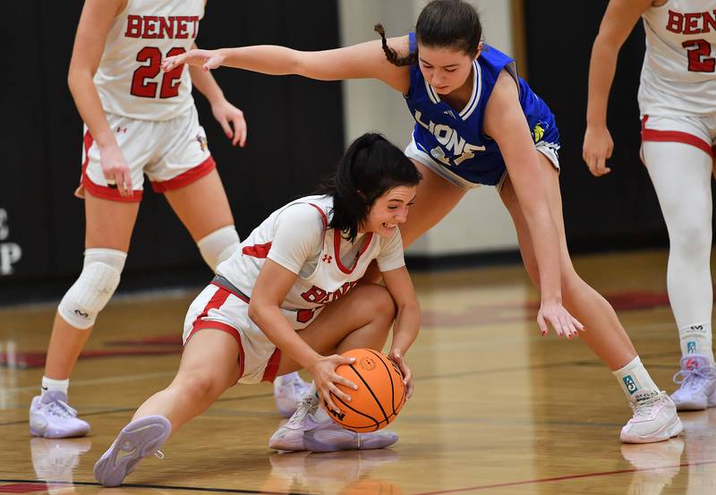 Benet’s Ava Thomas snags a loose ball from under Lyons Township’s Emma O'Brien during a game on November 18, 2025 at Benet Academy in Lisle.
