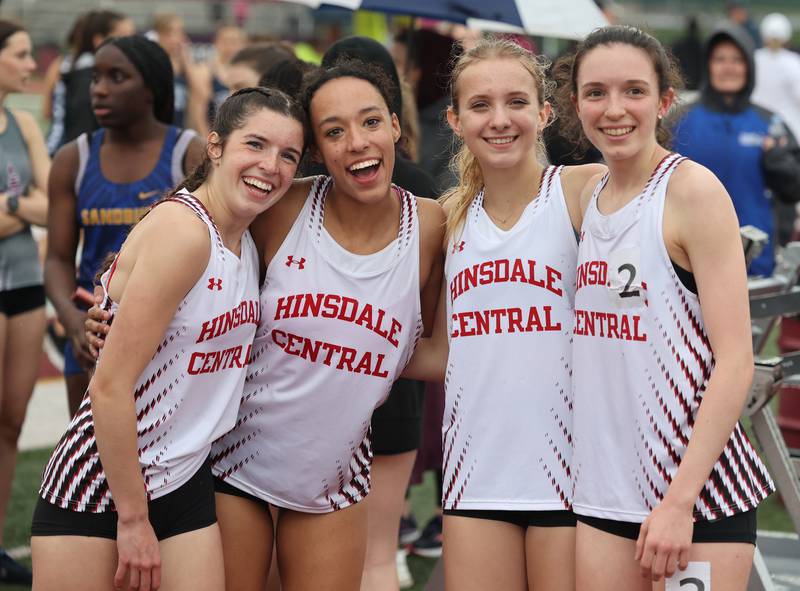 Hinsdale Central's 4 X 800 relay team are all smiles despite the rain during the girls varsity track and field 3A Lockport sectional on Friday, May 12, 2023.