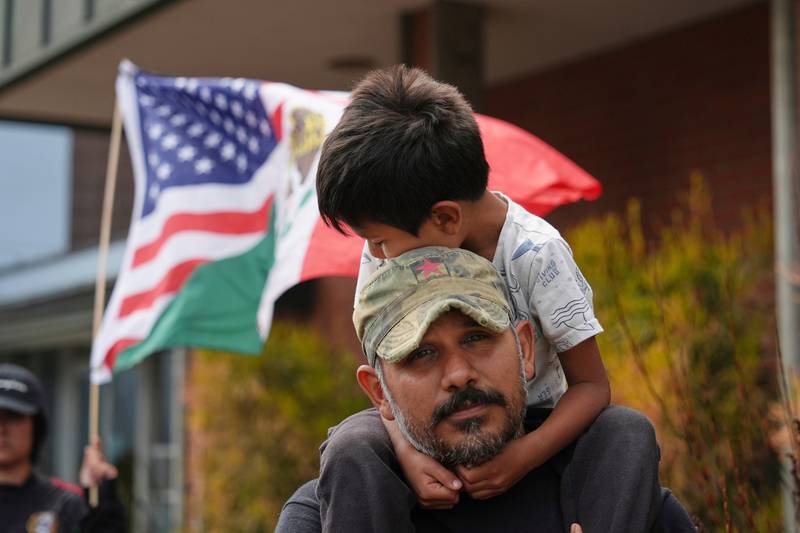 FILE - Gerardo Santos lifts his son Xavier, 5, on his shoulders during a protest in reaction to immigration raids, July 11, 2025, in Oxnard, Calif. (AP Photo/Jae C. Hong, File)
