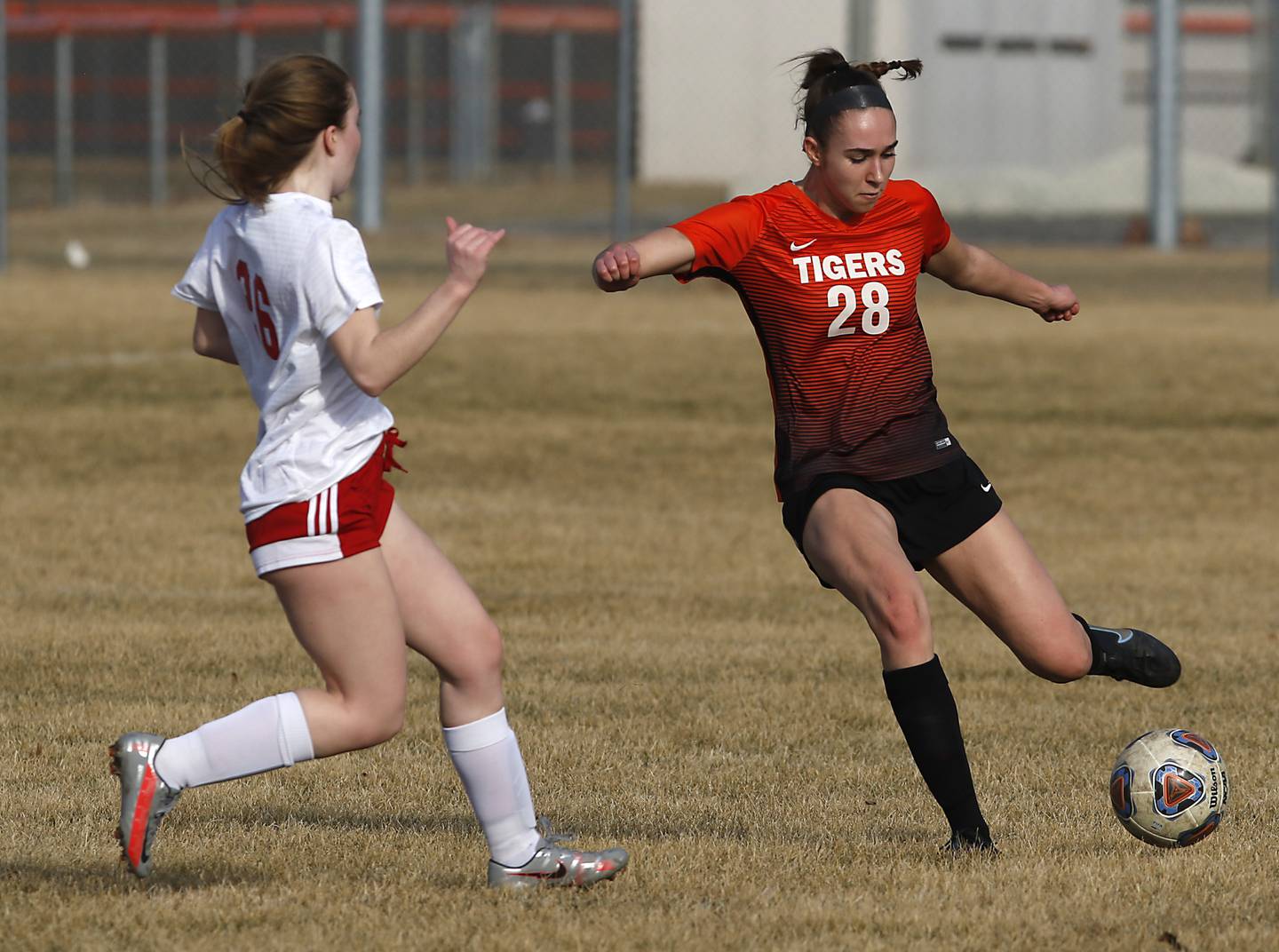 Crystal Lake Central's Jillian Mueller, right takes a shot on goal as she is guarded by Marian Central's Greta Fortin during a non-conference soccer match Monday, March 21, 2022, between Crystal Lake Central and Marian Central at Crystal Lake Central High School.