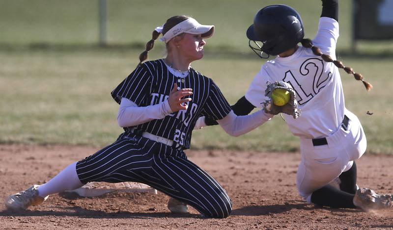 Crystal Lake Central's Kate Show can’t  tag out Huntley's Aubrina Adamik as she flies into second base during Fox Valley Conference softball game on Tuesday, April 8, 2025, at Huntley High School.