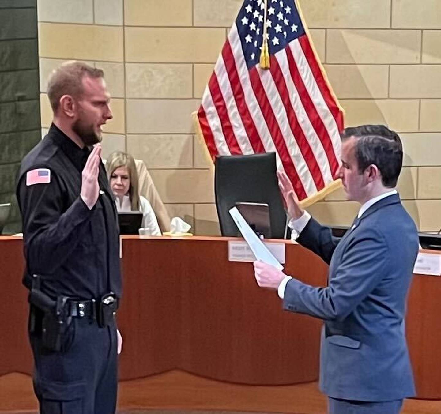 Montgomery Village President Matt Brolley swears in Kevin Lessner, left, as a village police officer during a Village Board meeting Monday, Jan. 23, 2023.