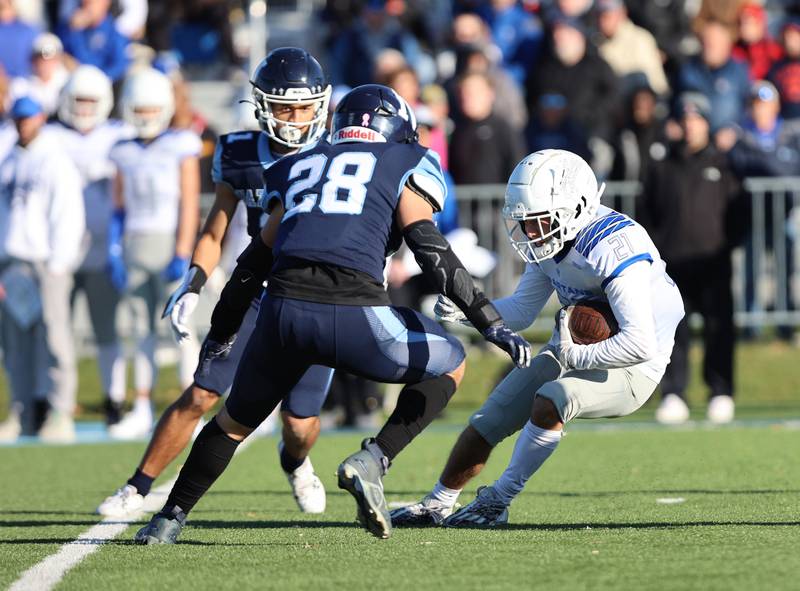 Nazareth's defense tries to shut down St. Francis' Cole Danner (21) run during the boys varsity IHSA 5A semifinal between Nazareth Academy and St. Francis high school in La Grange Park, IL on Saturday, Nov. 18, 2023.