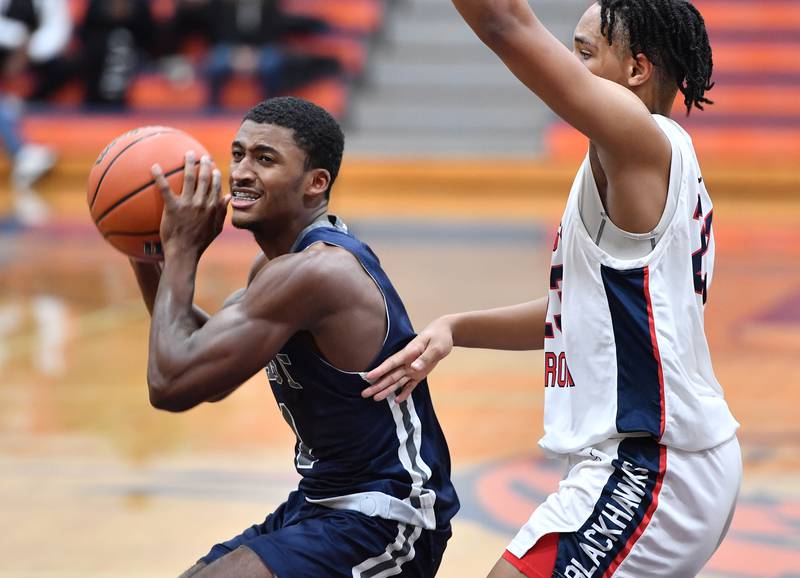 Oswego East's Andrew Wiggins (left) looks to pass as West AuroraÕs Andrew Wiggins defends during a Hoops for Healing tournament game on Nov. 20, 2023 at Naperville North High School in Naperville.