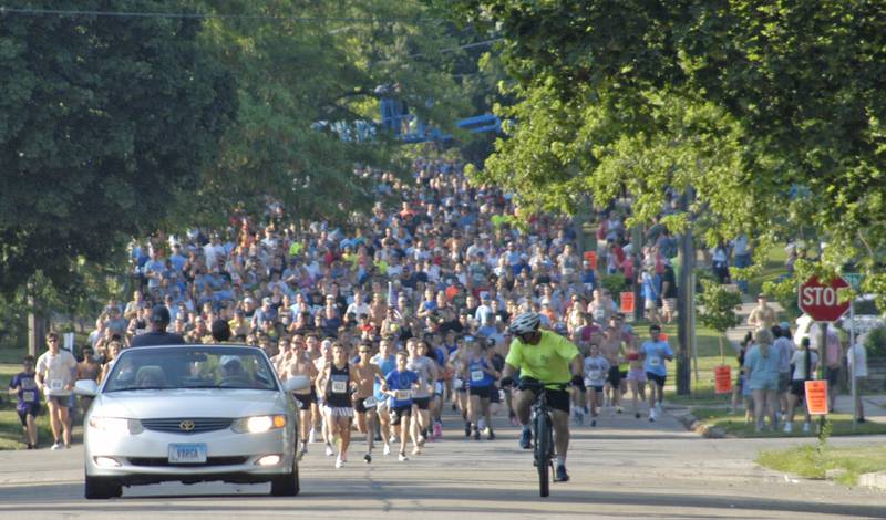 Runners make their way down Dixon's Hennepin Avenue on Saturday, July 5, 2025, at the start of the Reagan Run 5K. The Reagan Run is a highlight of the annual Dixon Petunia Festival.