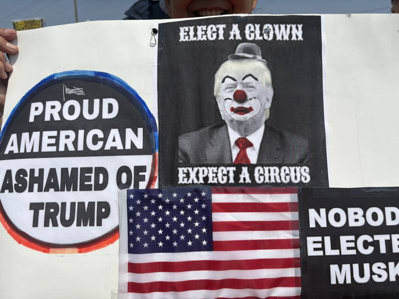 Maria Adams holds up a sign during a rally against President Donald Trump Saturday, May, 31, 2025.