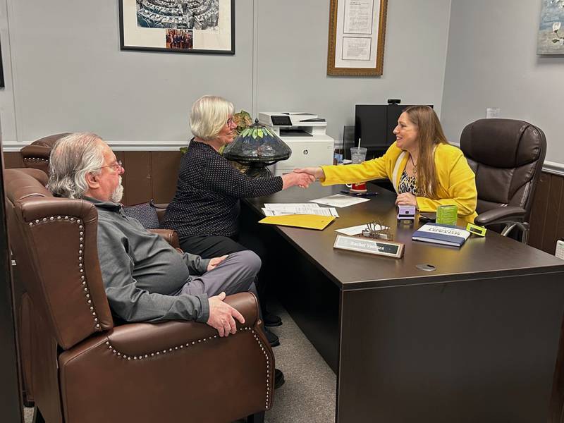 State Sen. Rachel Ventura, D-Joliet (right) shakes hands with Karen Pastell of Shorewood (left) while Karen Pastell's husband Paul Pastell. looks on. Ventura's office helped connect the Pastells with $10,000 of unclaimed property through ICash.