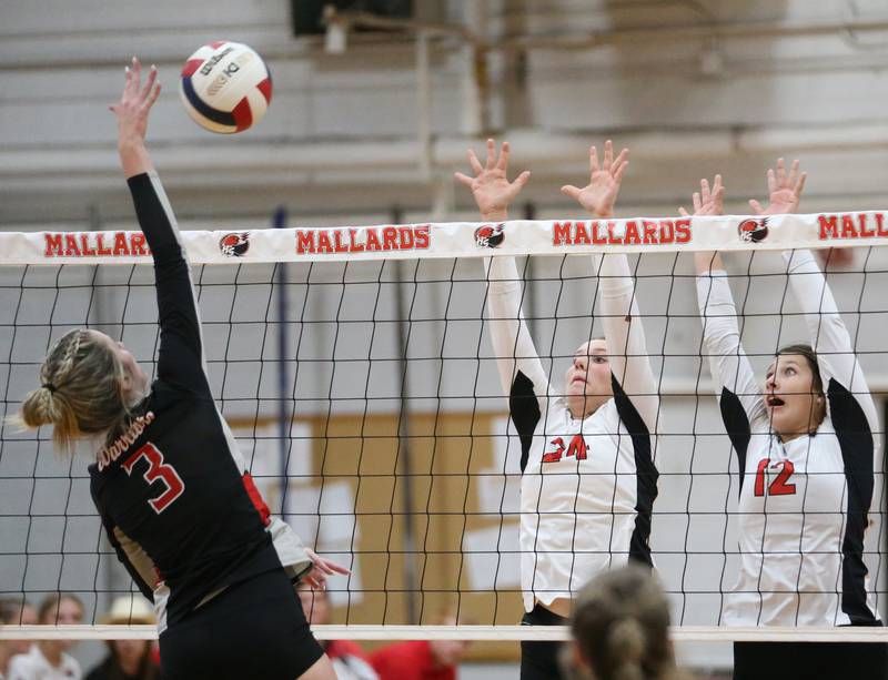 Woodland's Malayna Pitte sends a spike as Henry-Senachwine's Harper Schrock and Kaitlyn Anderson look to block it on Thursday, Oct. 3, 2024 at Henry-Senachwine High School.
