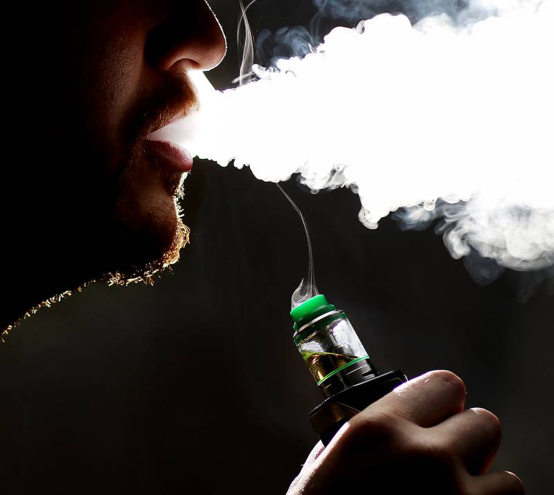 A man uses a vaping apparatus on Wednesday, June 26, 2019 in Elgin. Photo illustration by Matthew Apgar