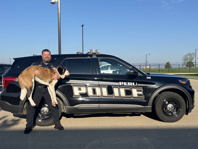 School Resource Officer Brian Zebron holds his partner, comfort dog Haven.