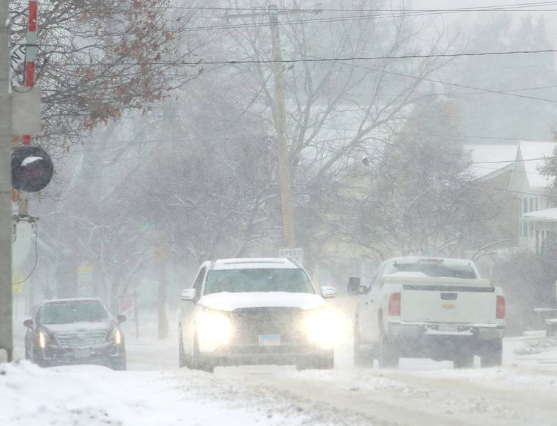 Motorists move along State Street during a snow storm in downtown Marengo on Saturday, November 29, 2025.