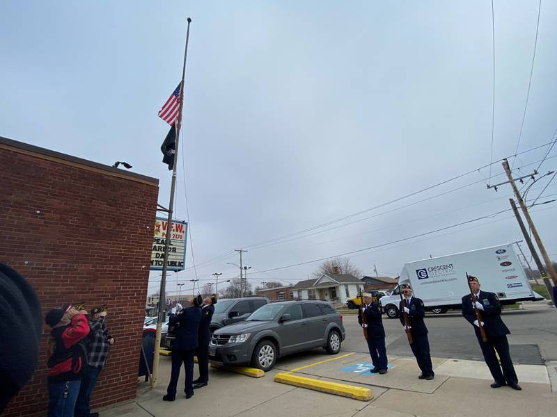 The Honor Guard raises the flags during the Ottawa VFW's ceremony honoring those who lost their lives during Pearl Harbor.