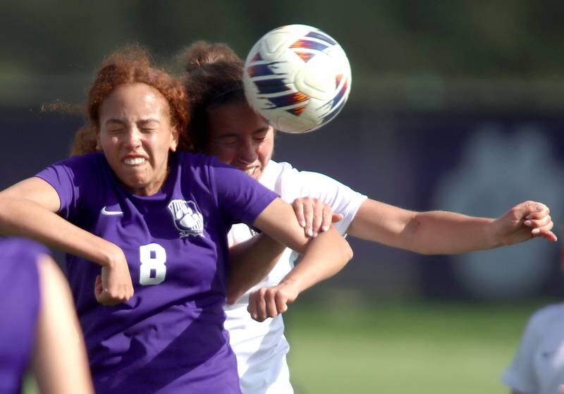 Hampshire’s Mikala Amegasse, front, battles Crystal Lake Central’s Shaylee Gough for the ball in varsity soccer at Hampshire Tuesday evening.