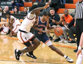 Naperville North's Luke Williams tries to get around DeKalb’s Marquise Bolden during their game Friday, Dec. 8, 2023, at DeKalb High School.