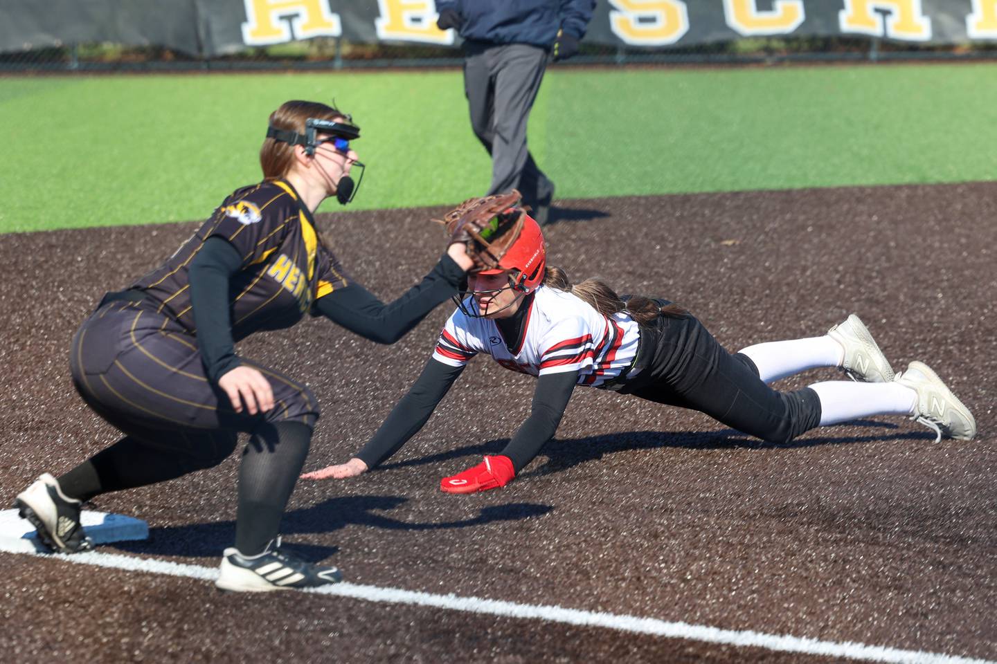 Bradley-Bourbonnais' Shannon Lee dives into third under the tag attempt by Herscher's Pippa Dunnill during their game on Monday, March 23, 2026.