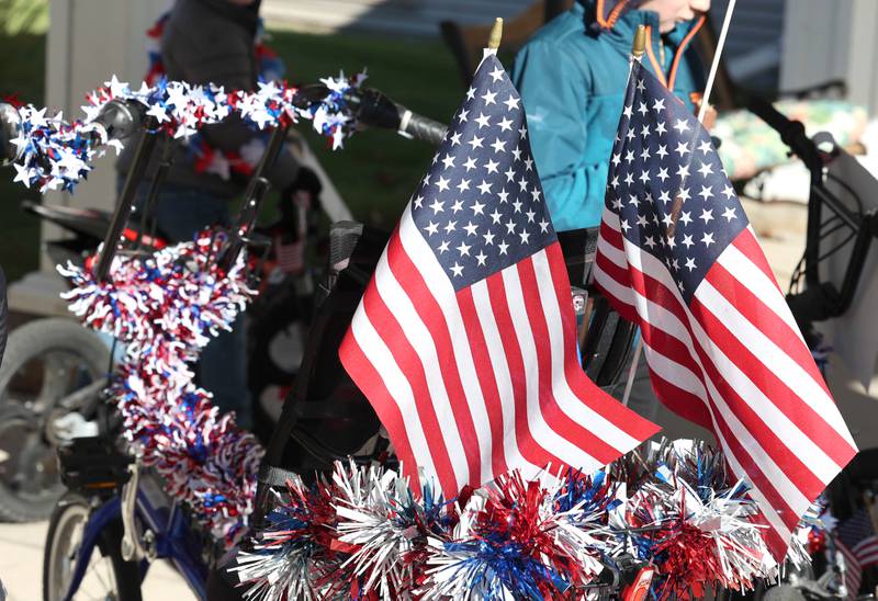 A bike is decorated for the parade put on by members of the Kunkel family on Veterans Day, Friday, Nov. 11, 2022, for the veterans at the Grand Victorian assisted living facility in Sycamore. Joann Kunkel read a story in the Midweek that contained a quote from one of the veterans at the facility that lamented the lack of a parade. So she and her grandkids decided to have one for them.