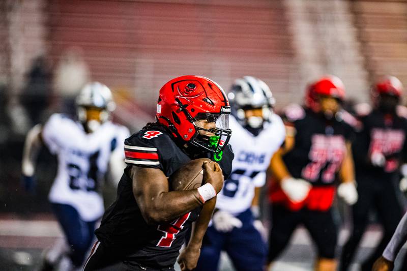 Bolingbrook's TJ Lewis runs the ball during a game against Oswego East on Friday Oct. 31, 2025 at Bolingbrook High School