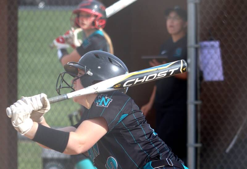Woodstock North’s Casey Vermett watches the flight of her first of two home runs against Jacobs in varsity softball at Algonquin Friday night.