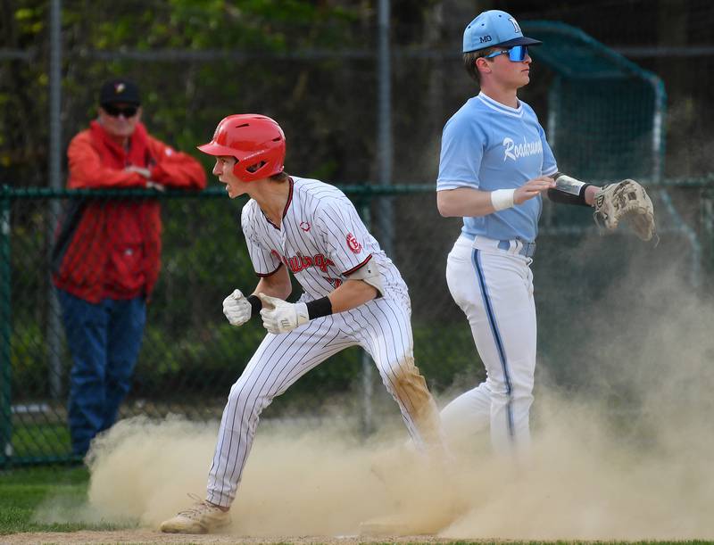 Benet's Ryan Cibulka (left) shouts towards the Benet dugout after hitting a triple during a game against Nazareth Academy on April 22, 2024 at Benet Academy in Lisle.