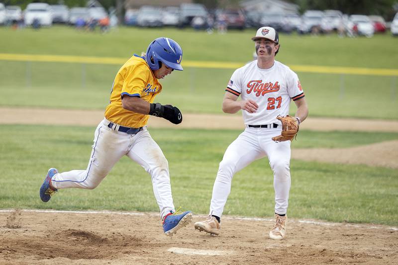 Johnsburg’s Dom Vallone scores on a wild pitch against Byron Wednesday, May 28, 2025, in the Class 2A Sectional semifinal in Mendota.