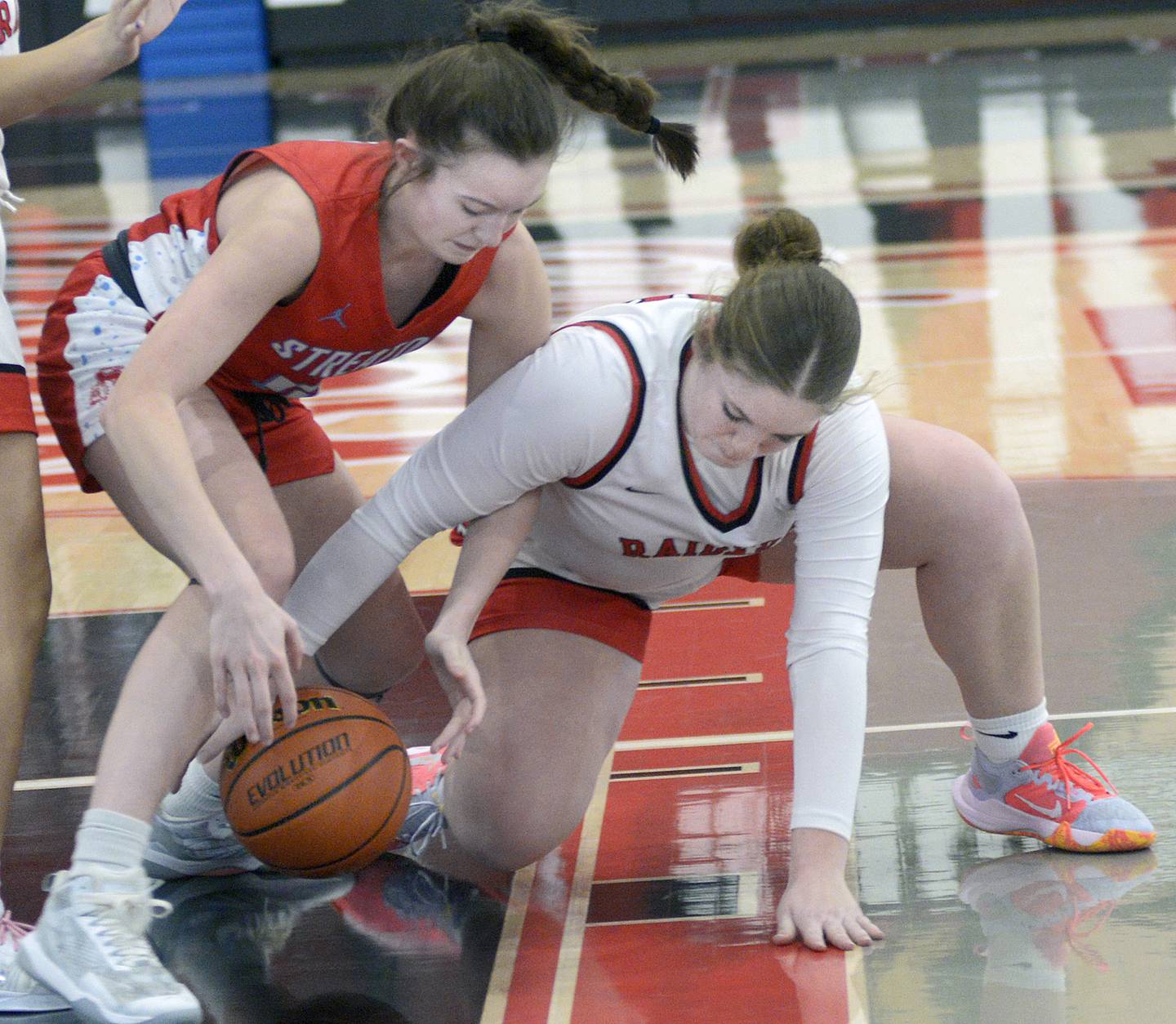 Streator’s Ava Gwaltney and Earlville’s Addie Scherer fight over a loose ball in the second quarter Saturday at Earlville.