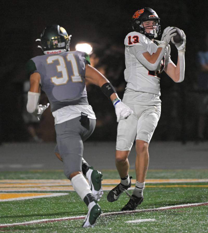 Libertyville’s Brock Williams makes a touchdown catch as Stevenson’s Ryan Harris defends in a football game in Lincolnshire on Friday, Sept. 13, 2024.