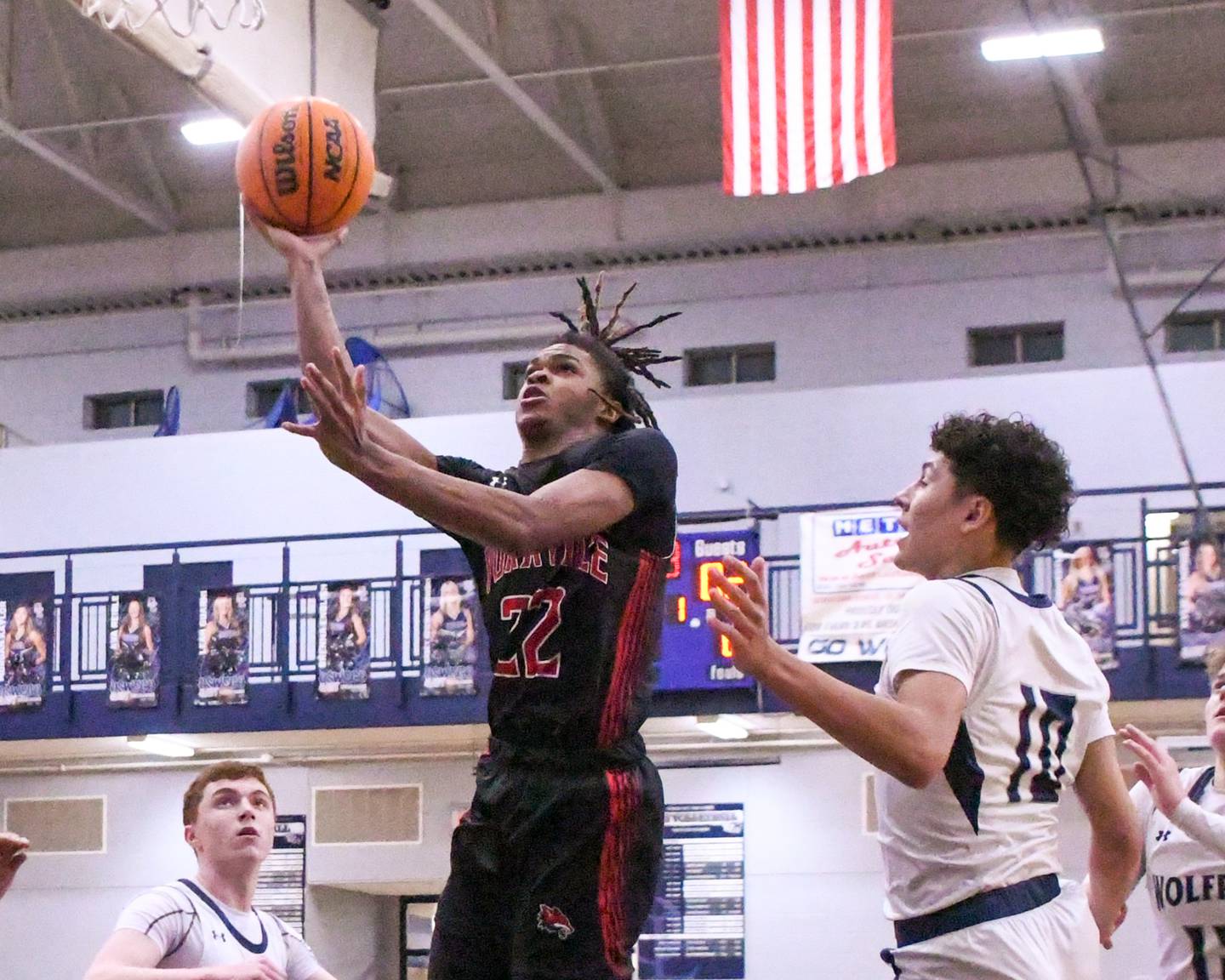Yorkville's Braydon Porter (22) takes a shot during the game while being defended by a pack of Oswego East players during the game on Friday Feb. 14, 2025, held at Oswego East High School.