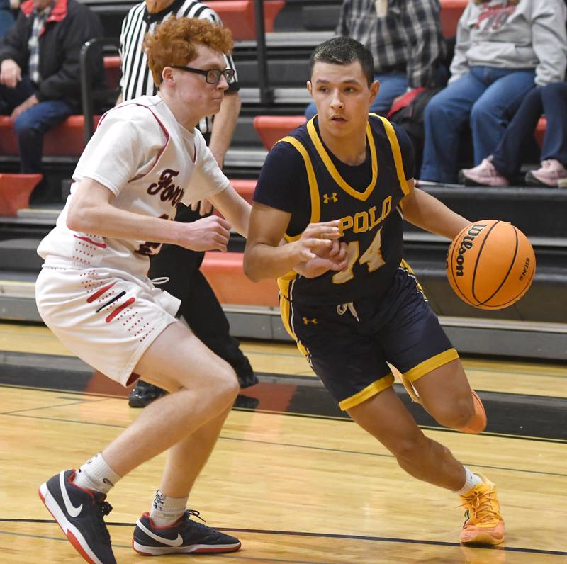 Polo's Jordan Reed (14) drives to the basket against a Forreston's Noah Genandt (25) on Saturday, Dec. 13, 2025 at the 64th Annual Forreston Holiday Basketball Tournament held at Forreston High School.