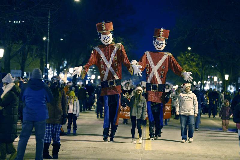 Giant nutcrackers make their way down Third Street during Candy Cane Parade Friday, Dec. 6, 2024 in Geneva.