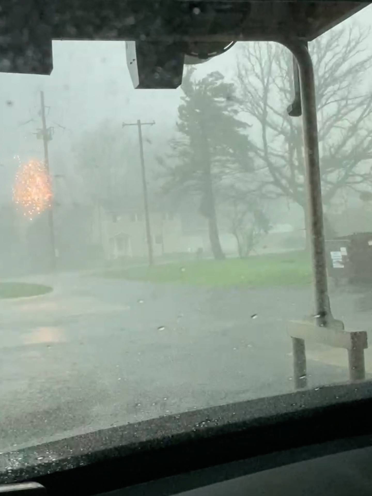 Sparks fly from a utility pole damage from a major storm in Lena, Ill., on Friday, April 17, 2026 in Lena, Ill.    (Rachel Nemon via AP)