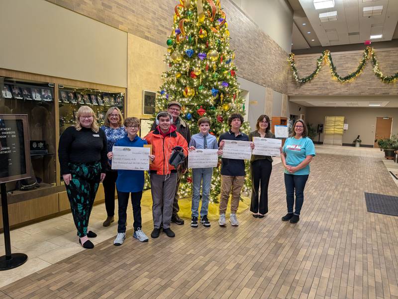 The winners of the Community Foundation of Grundy County's philanthropy essay contest with representatives from the organizations they chose to donate their winnings to.