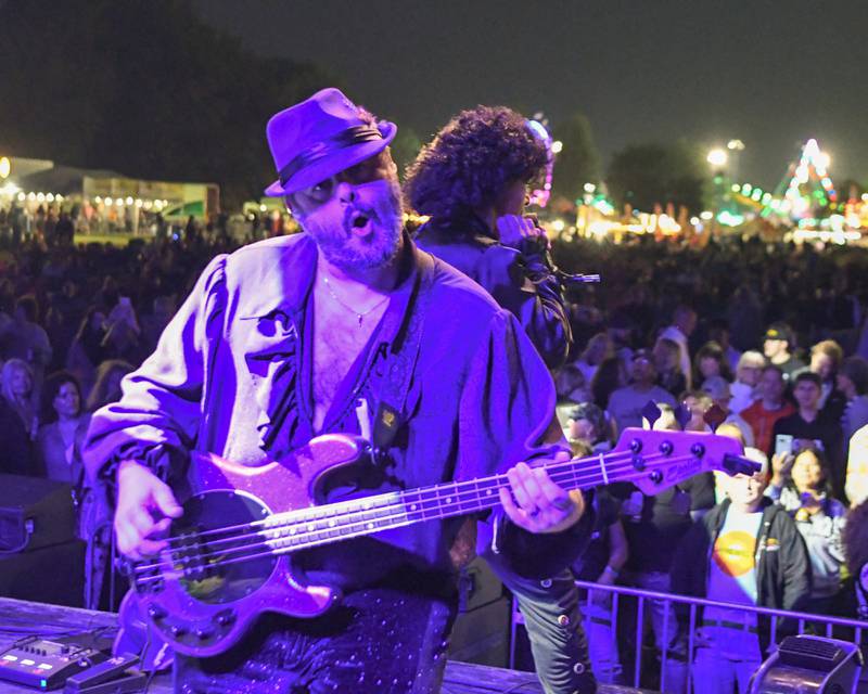A band amember of The Prince Experience a Prince Tribute band hams up the camera during PrairieFest on Thursday June 12, 2025, held at PrairieFest Park in Oswego.