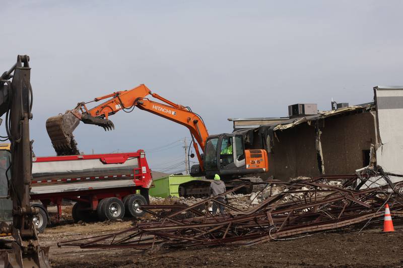 Excavators demolish a portion of the Bill Walsh Coronet Dodge Chrysler Jeep RAM Jeep dealership on Tuesday, Feb. 17, 2026 in Peru.