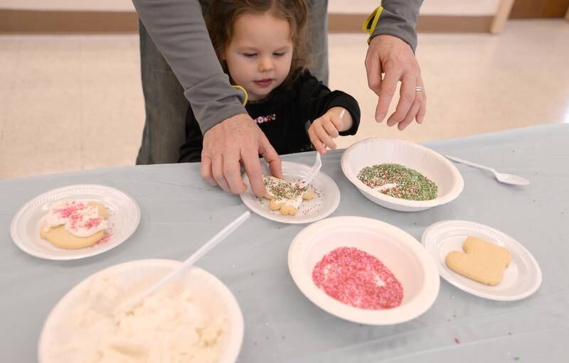 Charlotte Steinke of Downers Grove decorates a Christmas cookie while attending Downers Grove Park District's Candy Cane Lane Saturday, Dec. 2, 2023.