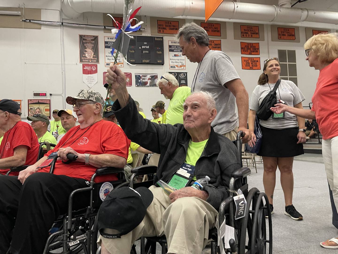 Bill Sensor, an army veteran, waves and cheers after being welcomed into McHenry High School. Sensor was one of 51 veterans who went on the Honor Flight over the weekend to visit war memorials in Washington D.C., Sunday, Aug. 28, 2022, and were welcomed home at McHenry High School.