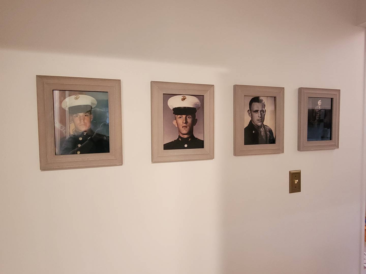 A "military wall" in Shannon Anderson's home shows military servicemen in his family, including his grandfather, his wife's father and grandfather, and himself.